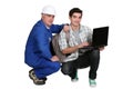 A tradesman helping his apprentice Royalty Free Stock Photo