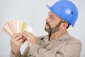 Tradesman holding fanned out colour samples