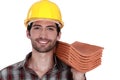 Tradesman holding shingles