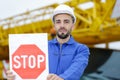 Tradesman holding stop sign