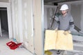 Tradesman installing insulation