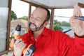 tradesman looking with gratitude at cordless screwdriver