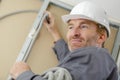 tradesman putting up cable trunking Royalty Free Stock Photo