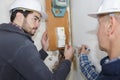 Tradesman repairing distribution board