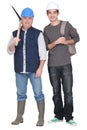 Tradesman standing next to apprentice Royalty Free Stock Photo