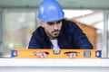 tradesman using bubble level on wall