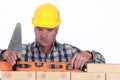 Tradesman using a level