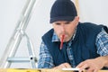 Tradesman working with pencil in mouth Royalty Free Stock Photo