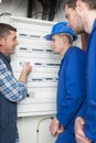 Tradesmen and apprentices installing distribution board Royalty Free Stock Photo