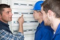 Tradesmen showing apprentices fuse board Royalty Free Stock Photo