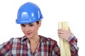 Tradeswoman holding wood Royalty Free Stock Photo
