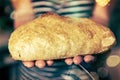 Tradiional Italian ciabatta bread on hands