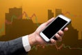 Trading Businessman hold smart phone.and Forex Trading Line Graphs