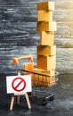 Trading cart with boxes and an easel with a prohibition symbol NO. Internet trade online shopping ban. Restriction on importation