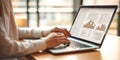 Female financial analyst in eyeglasses works in front of a laptop monitor. Royalty Free Stock Photo