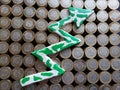 arrow up formed with plasticine in green and white and stacked coins of mexican pesos