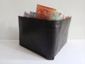 black leather wallet with australian banknotes and white background Royalty Free Stock Photo