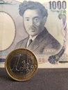 coin of one euro and japanese banknote of 1000 yen