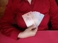 hand of a businesswoman holding brazilian banknotes