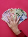 hand of a businesswoman holding mexican banknotes