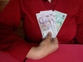 hand of a businesswoman holding singaporean banknotes Royalty Free Stock Photo