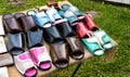 Trading in the market of shoes with flip flops made of genuine leather. Multicolour woven leather sandals, comfortable