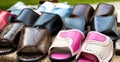 Trading in the market of shoes with flip flops made of genuine leather. Multicolour woven leather sandals, comfortable