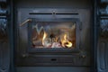 Tradional black Wood Burning Stove close-up with fire flames, antique design cozy Royalty Free Stock Photo