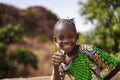 Tradionally Dresses Small African Girl Making The Thumbs-Up Sign