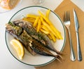 Grilled mackerel fish with french fries and lemon Royalty Free Stock Photo