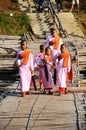 Tradition of almsgiving Burmese nuns women group procession walk on bridge for thai people respect praying put food offerings in