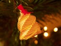 Tradition Christmas bell decoration made from dry straw. Christmas tree with small gentle lights. Royalty Free Stock Photo