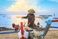 Tradition colorful fishing boat lays on sandy Jimbaran