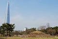 Tradition and modernity: Baekje grave sites in front of skyline, Seoul, Korea Royalty Free Stock Photo