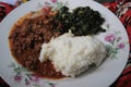 Traditional African cuisine for poor people - cornmeal porridge Maize or Ishim with spinach