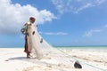 Traditional african local rural fishing on Paje beach, Zanzibar, Tanzania. Traditionally dressed local woman pulling