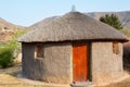 Traditional african round clay house with thatched roof in village, Kingdom of Lesotho, Southern Africa Royalty Free Stock Photo