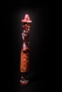 Traditional African sculpture of a man in colored wood on black Background Royalty Free Stock Photo