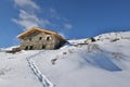 alpine chalet at the top of snowy mountain under blue sky Royalty Free Stock Photo