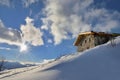 chalet at the top of snowy mountain under sunrise in the  sky Royalty Free Stock Photo