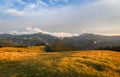 Traditional alpine house  and mountain pastures at sunset in summer. Panoramic view on Mountain valley, summits,  meadows and Royalty Free Stock Photo