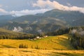 Traditional alpine house  and mountain pastures at sunset in summer. Panoramic view on Mountain valley, summits,  meadows and Royalty Free Stock Photo
