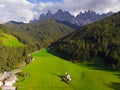 Traditional alpine St Johann church in Val di Funes valley, Santa Maddalena touristic village, Dolomites, Italy. Grass, chapel. Royalty Free Stock Photo