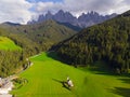 Traditional alpine St Johann church in Val di Funes valley, Santa Maddalena touristic village, Dolomites, Italy. Grass, chapel. Royalty Free Stock Photo