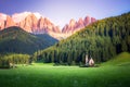 Traditional alpine St Johann church in Val di Funes valley, Santa Maddalena touristic village, Dolomites, Italy.