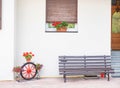 Traditional Alps front door. Wooden bench, flowers and some decoration