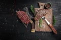 Traditional American barbecue dry aged rump steak from sliced on a board butcher and fork. banner, menu recipe place for text, top Royalty Free Stock Photo