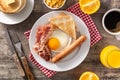 Traditional American breakfast with fried egg,toast,bacon and sausage on wooden table Royalty Free Stock Photo