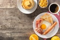 Traditional American breakfast with fried egg,toast,bacon and sausage on wooden table Royalty Free Stock Photo