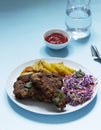 A traditional American dinner of fried ribs, fried potatoes and coleslaw. Royalty Free Stock Photo